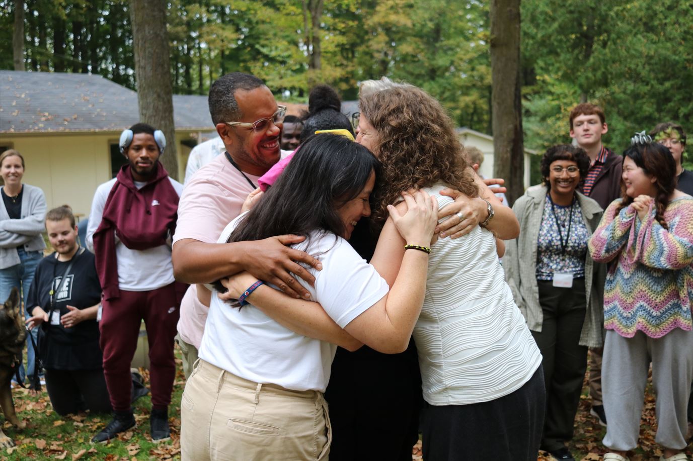 A group of adult allies at DTL, hugging.